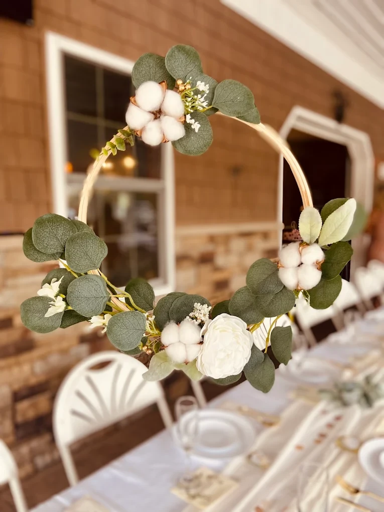 Handcrafted floral hoop centerpiece with eucalyptus and cotton at Starr Hill Vineyard & Winery reception