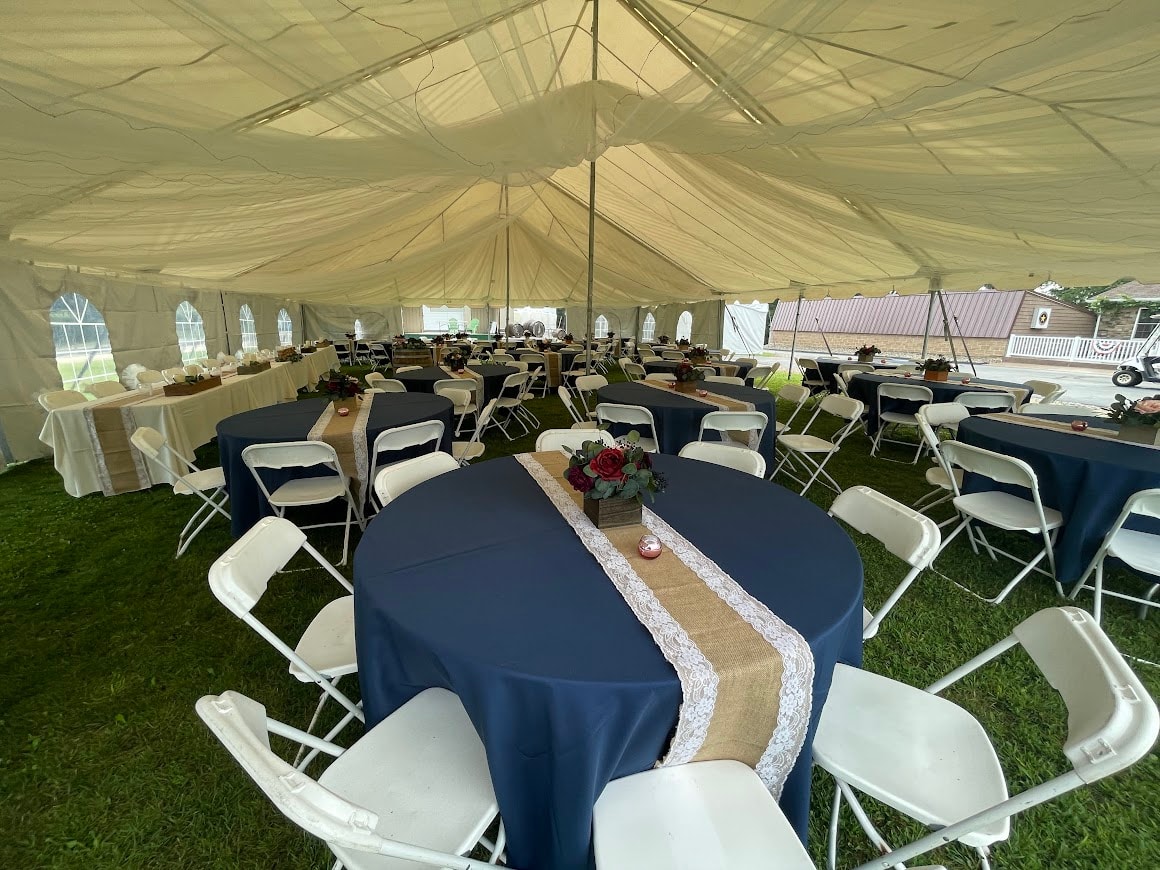 Wedding reception tables set up inside tent at Starr Hill Vineyard