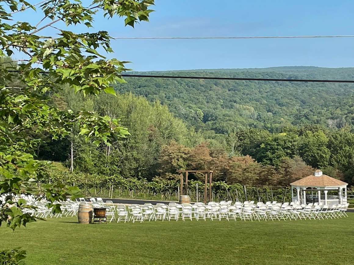 Wedding ceremony chairs set up in front of vineyard and gazebo at Starr Hill Vineyard & Winery